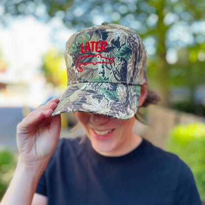 Camouflage hat embroidered with later and image of gator