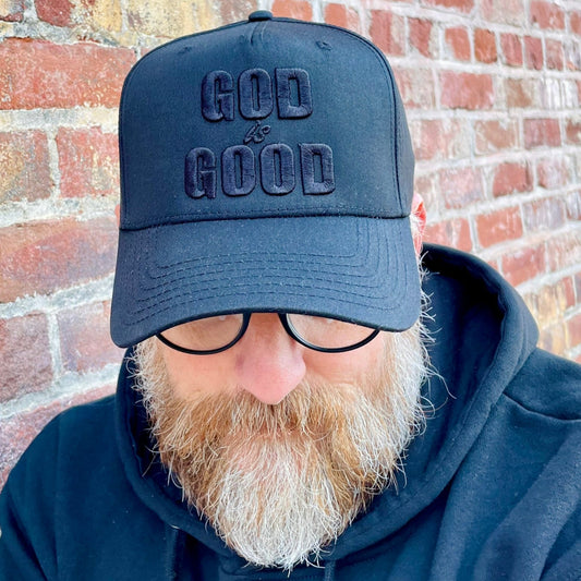 Black hat with God is Good embroidered on it