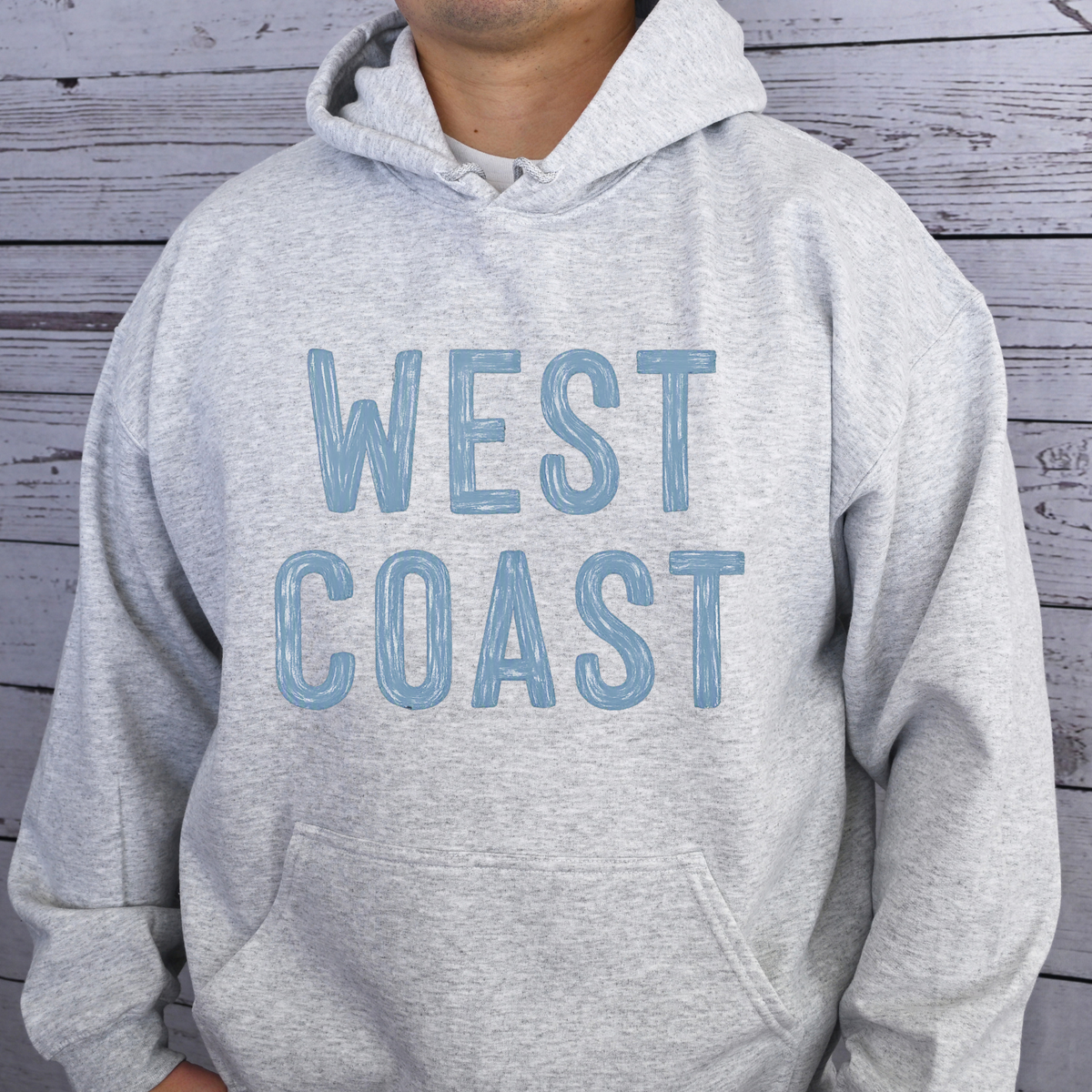 West Coast design that appears painted onto a gray hooded sweatshirt.